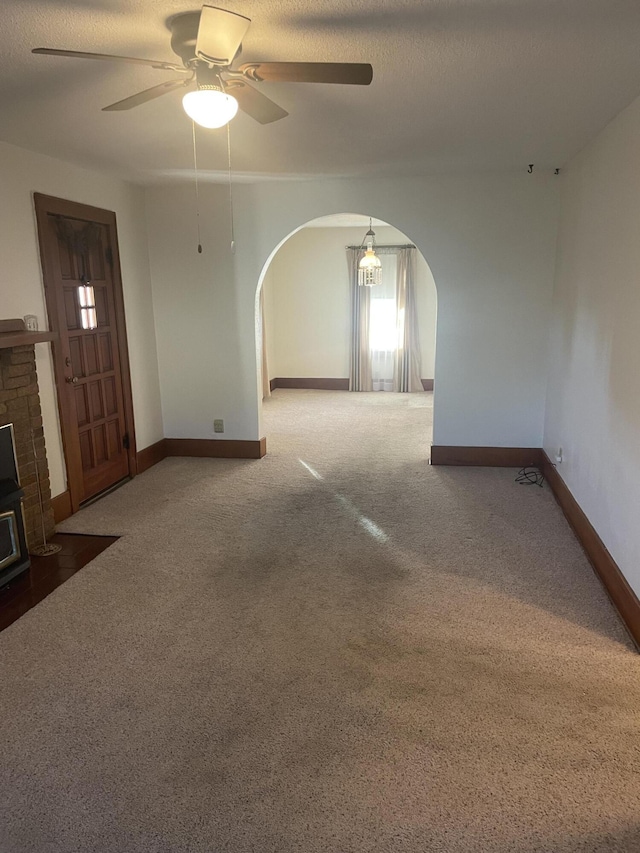 empty room with ceiling fan and carpet flooring