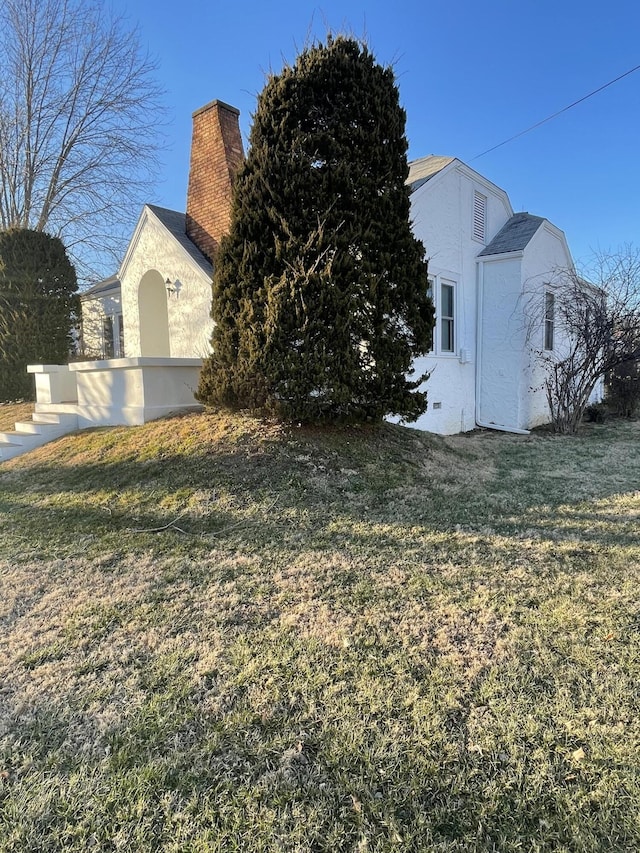 view of property exterior featuring a lawn