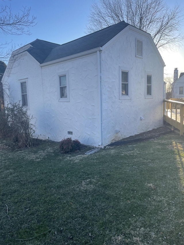 view of property exterior with a yard