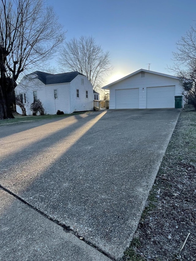 view of side of home with a garage and an outdoor structure