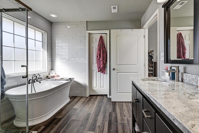 21 Meadow Brook Ln, Anderson, MO 64831 - bathroom with vanity, plenty of natural light, a tub, and tile walls