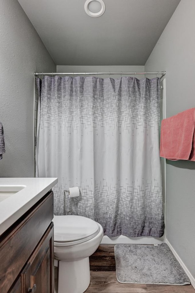 21 Meadow Brook Ln, Anderson, MO 64831 - full bathroom featuring vanity, hardwood / wood-style floors, shower / tub combo, and toilet