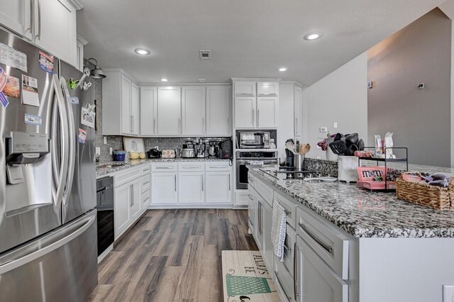21 Meadow Brook Ln, Anderson, MO 64831 - kitchen with white cabinetry, appliances with stainless steel finishes, light stone countertops, and hardwood / wood-style floors