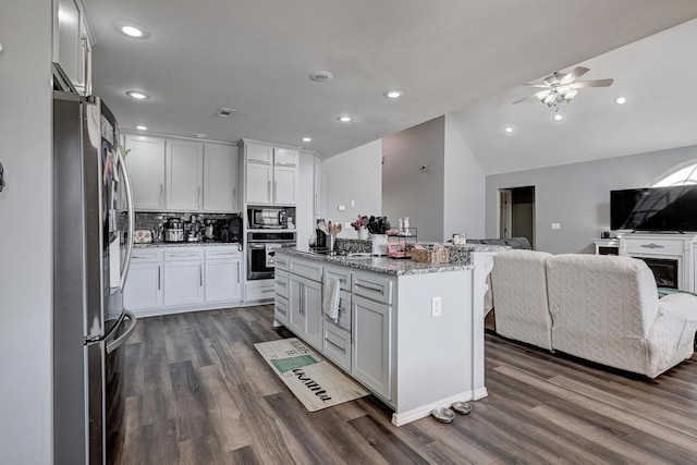 21 Meadow Brook Ln, Anderson, MO 64831 - kitchen featuring white cabinetry, light stone counters, a kitchen island, stainless steel appliances, and decorative backsplash