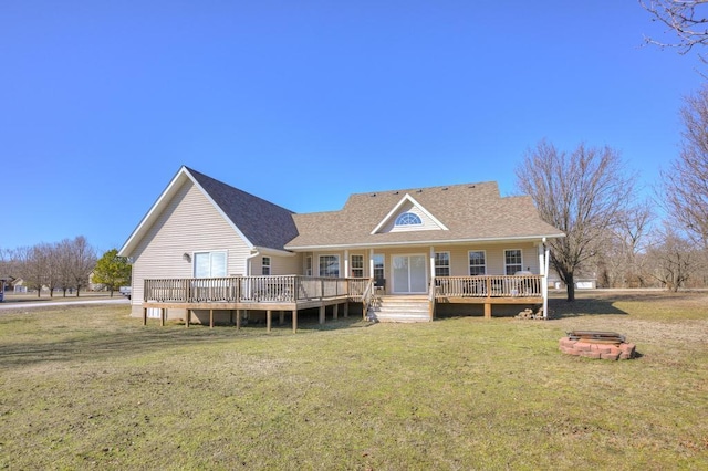 21 Meadow Brook Ln, Anderson, MO 64831 - back of property featuring a wooden deck, a lawn, and an outdoor fire pit