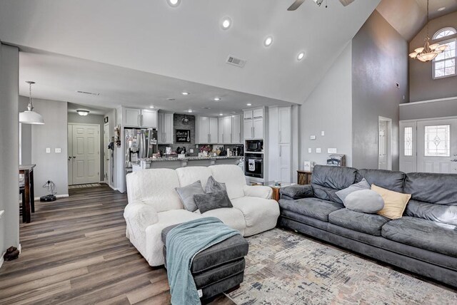 21 Meadow Brook Ln, Anderson, MO 64831 - living room with dark hardwood / wood-style flooring, ceiling fan with notable chandelier, and high vaulted ceiling