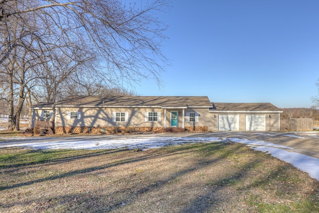 ranch-style home featuring a garage