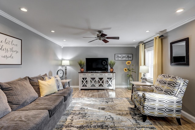 living room with crown molding, hardwood / wood-style floors, and ceiling fan