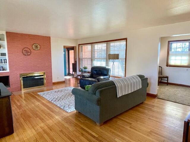 living room featuring light hardwood / wood-style flooring and a fireplace