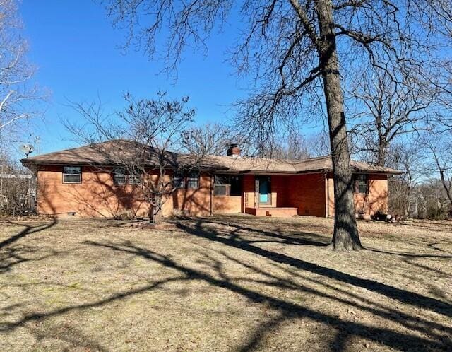 rear view of property with a yard