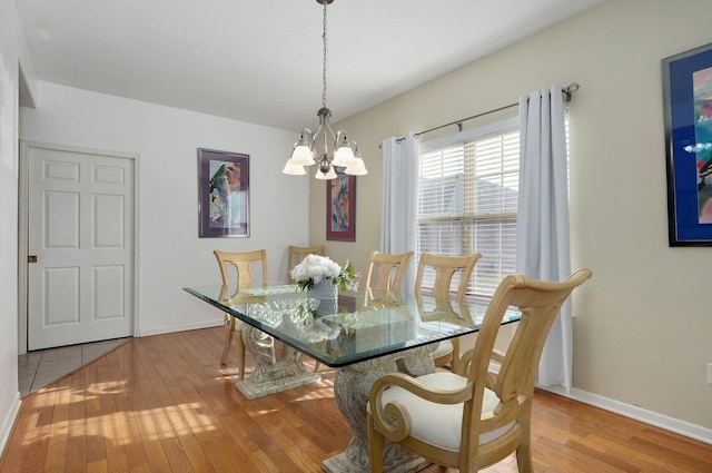 dining room featuring an inviting chandelier and light hardwood / wood-style floors