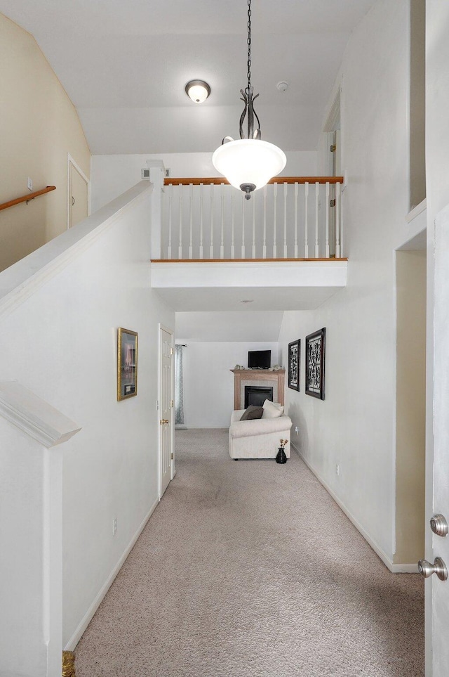 interior space with a towering ceiling and carpet flooring