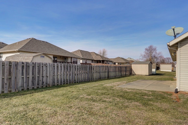 view of yard featuring a storage unit and a patio area