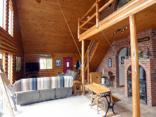 interior space with a high ceiling, wood ceiling, and wood walls