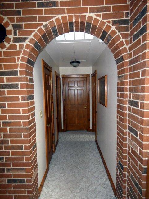 hall with light colored carpet