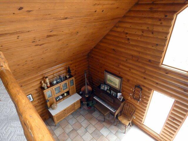 living room featuring wood ceiling and vaulted ceiling