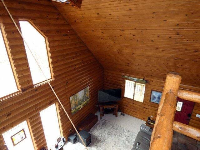 bonus room with wood ceiling, wooden walls, vaulted ceiling, and a wealth of natural light