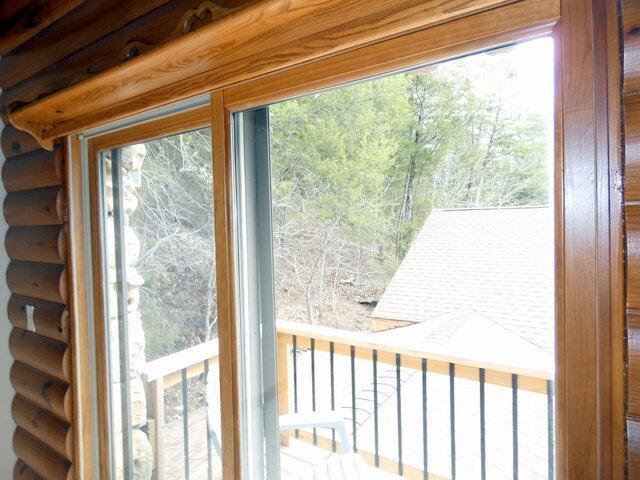 doorway to outside with rustic walls