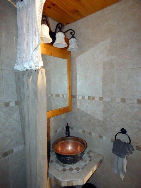 bathroom with sink, a shower with curtain, and wooden ceiling