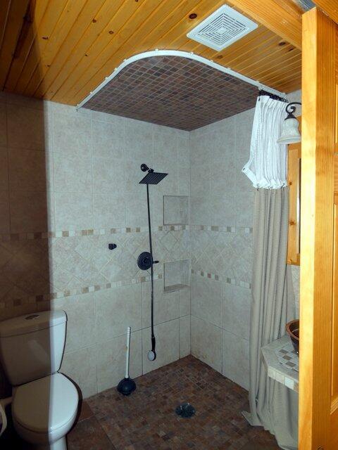 bathroom featuring toilet and a shower with shower curtain