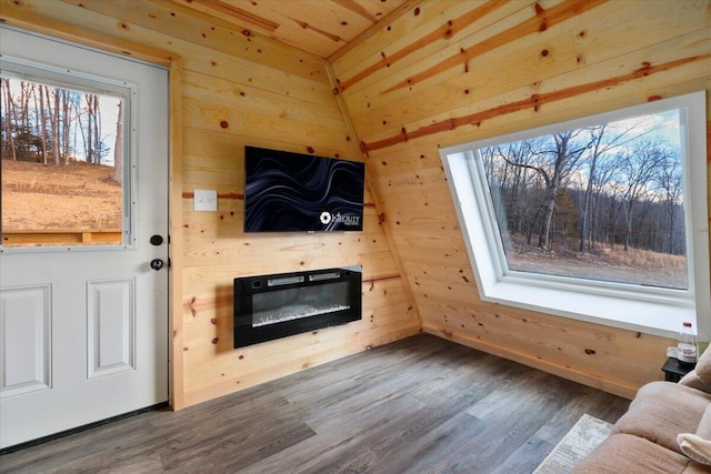 living room with hardwood / wood-style flooring and wood walls