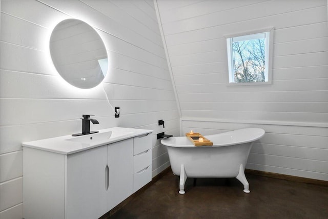 bathroom featuring vanity, concrete flooring, and a washtub