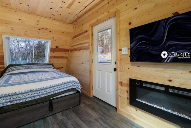 bedroom featuring wooden ceiling, dark hardwood / wood-style flooring, and wood walls