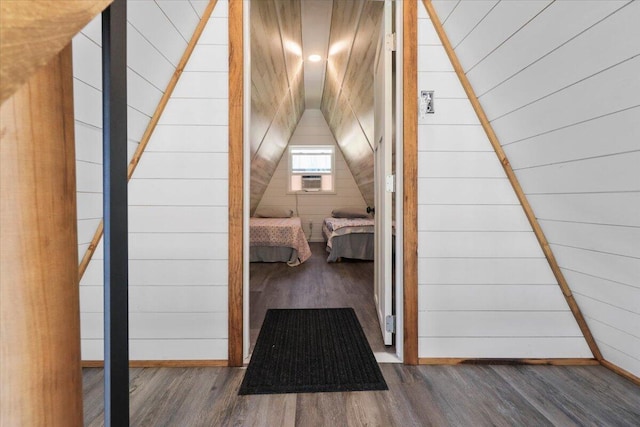 interior space with cooling unit, dark hardwood / wood-style flooring, and wood walls