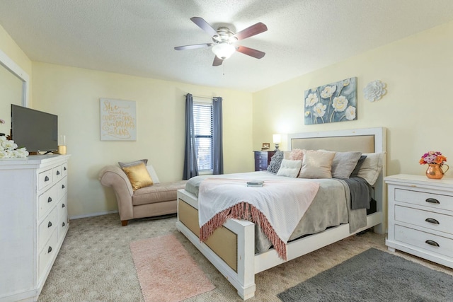 carpeted bedroom featuring a textured ceiling and ceiling fan