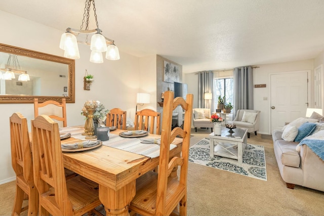 carpeted dining area with a textured ceiling