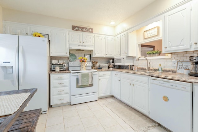 kitchen featuring tasteful backsplash, sink, white cabinets, light tile patterned floors, and white appliances