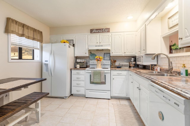 kitchen featuring light tile patterned flooring, sink, white cabinetry, white appliances, and backsplash