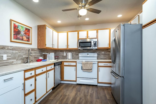 kitchen featuring white cabinetry, appliances with stainless steel finishes, dark wood-type flooring, and sink