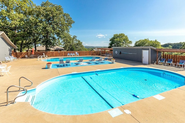 view of pool with a jacuzzi and a patio area