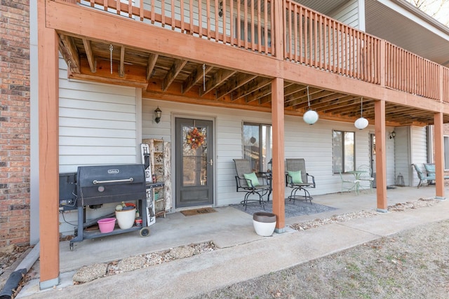 view of exterior entry with a patio