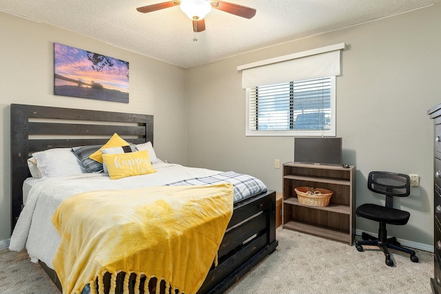 carpeted bedroom featuring a textured ceiling and ceiling fan