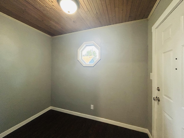 empty room with ornamental molding and wooden ceiling