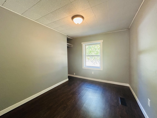 empty room with dark wood-type flooring