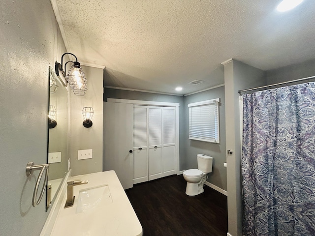 bathroom with toilet, a shower with curtain, a textured ceiling, vanity, and hardwood / wood-style floors