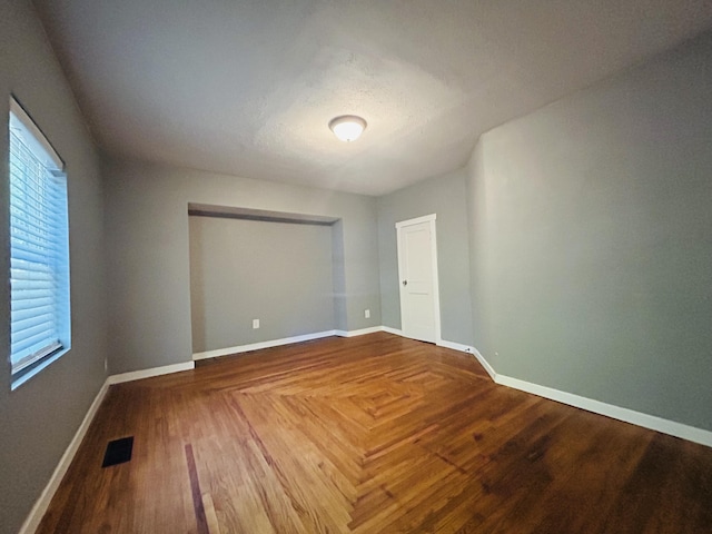 spare room with wood-type flooring