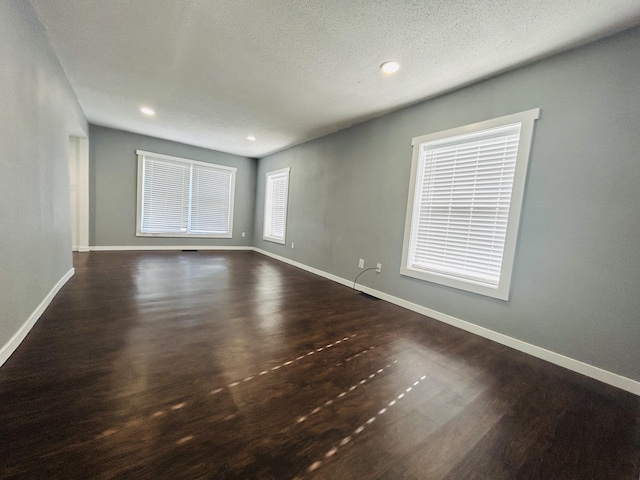 unfurnished room featuring a textured ceiling