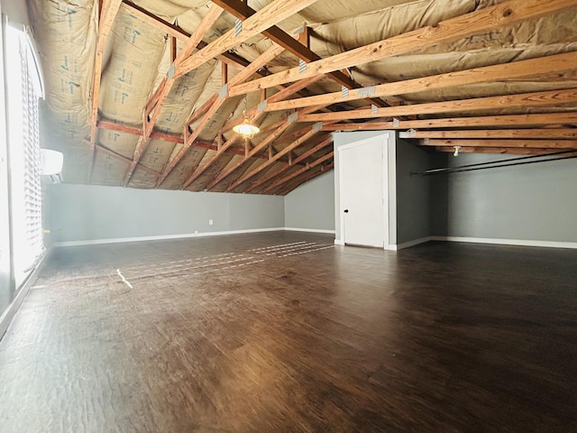 bonus room featuring dark wood-type flooring and lofted ceiling