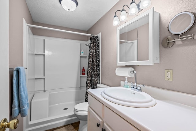 bathroom featuring a shower with curtain, vanity, toilet, and a textured ceiling