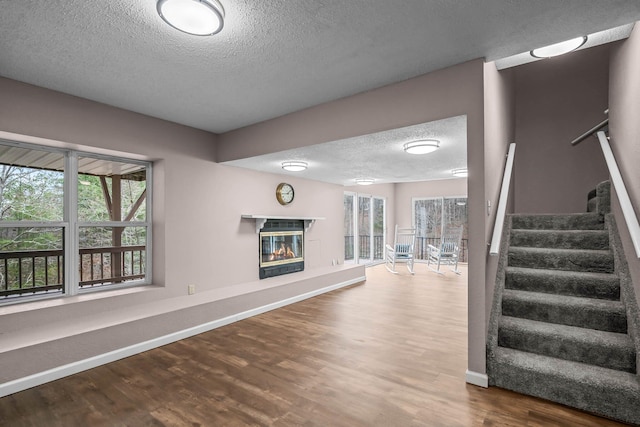 staircase featuring hardwood / wood-style flooring and a textured ceiling