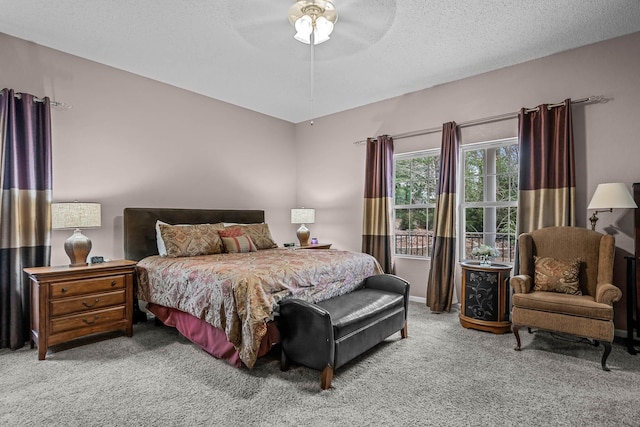 bedroom with carpet floors, a textured ceiling, and ceiling fan