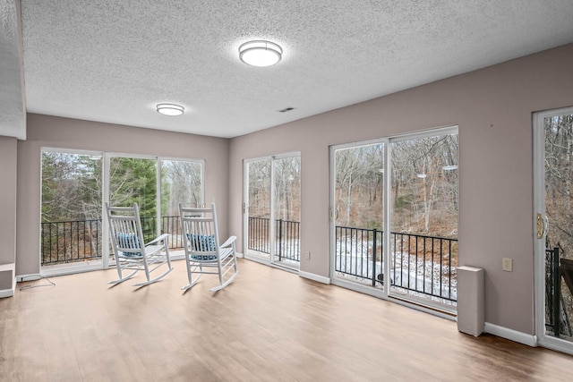 unfurnished sunroom with plenty of natural light