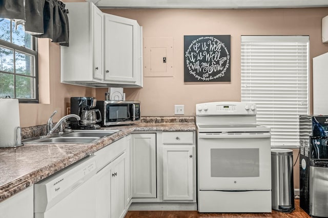 kitchen with white cabinetry, sink, white appliances, and electric panel