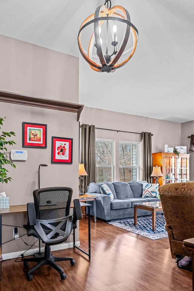 living room with wood-type flooring, a chandelier, and a textured ceiling