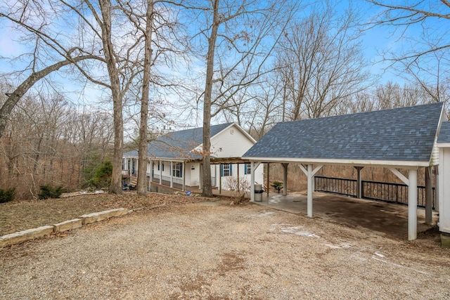 back of house with a carport