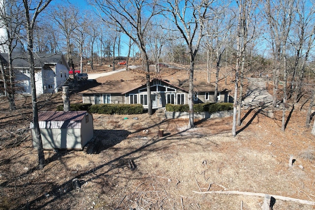 view of front of home with a shed